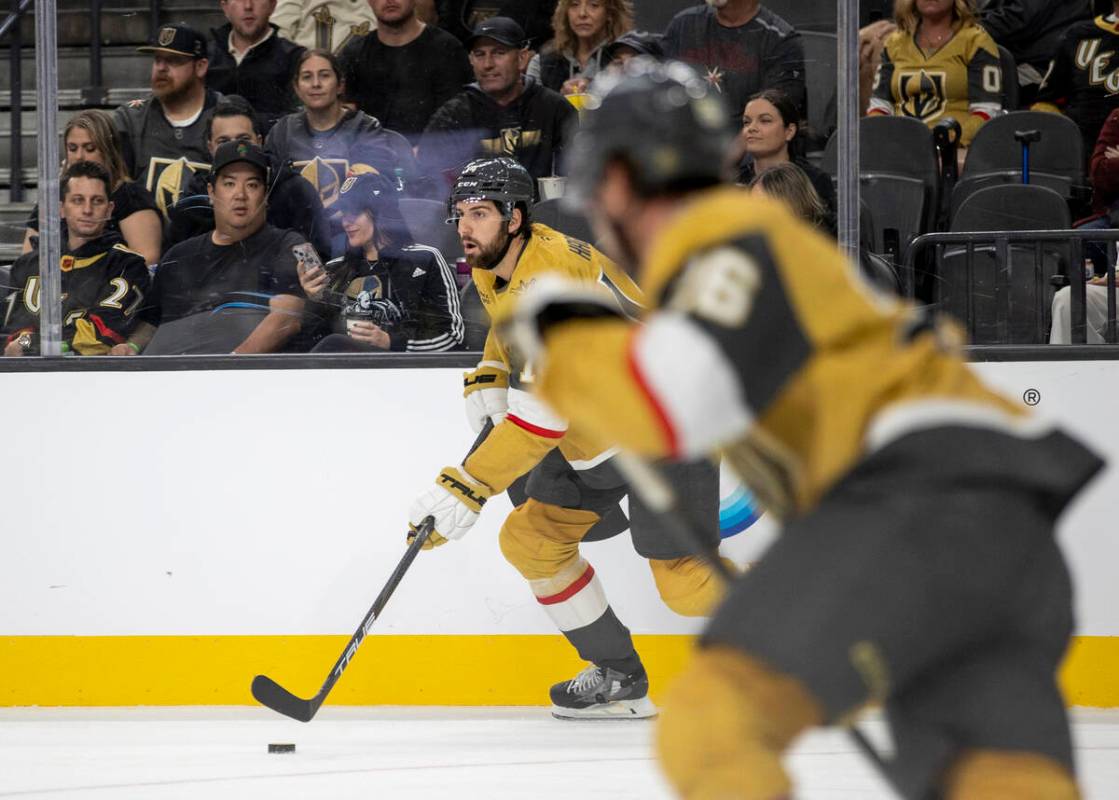 Golden Knights defenseman Nicolas Hague (14) skates with the puck during the NHL hockey game ag ...