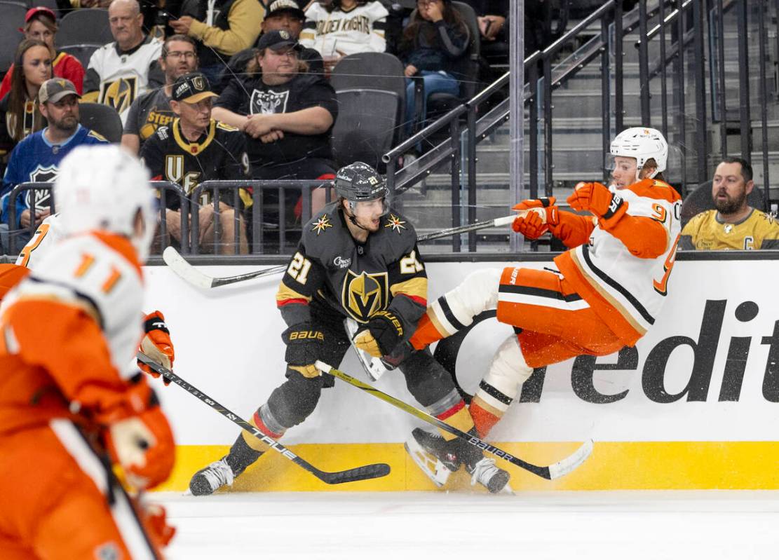 Golden Knights center Brett Howden (21) delivers a blow on Anaheim Ducks center Leo Carlsson (9 ...
