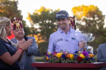 J.T. Poston holds the trophy after winning the Shriners Children’s Open at TPC Summerlin ...
