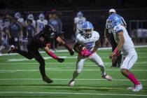 Centennial running back Khy Harris (5) runs the ball under pressure from Las Vegas defensive en ...