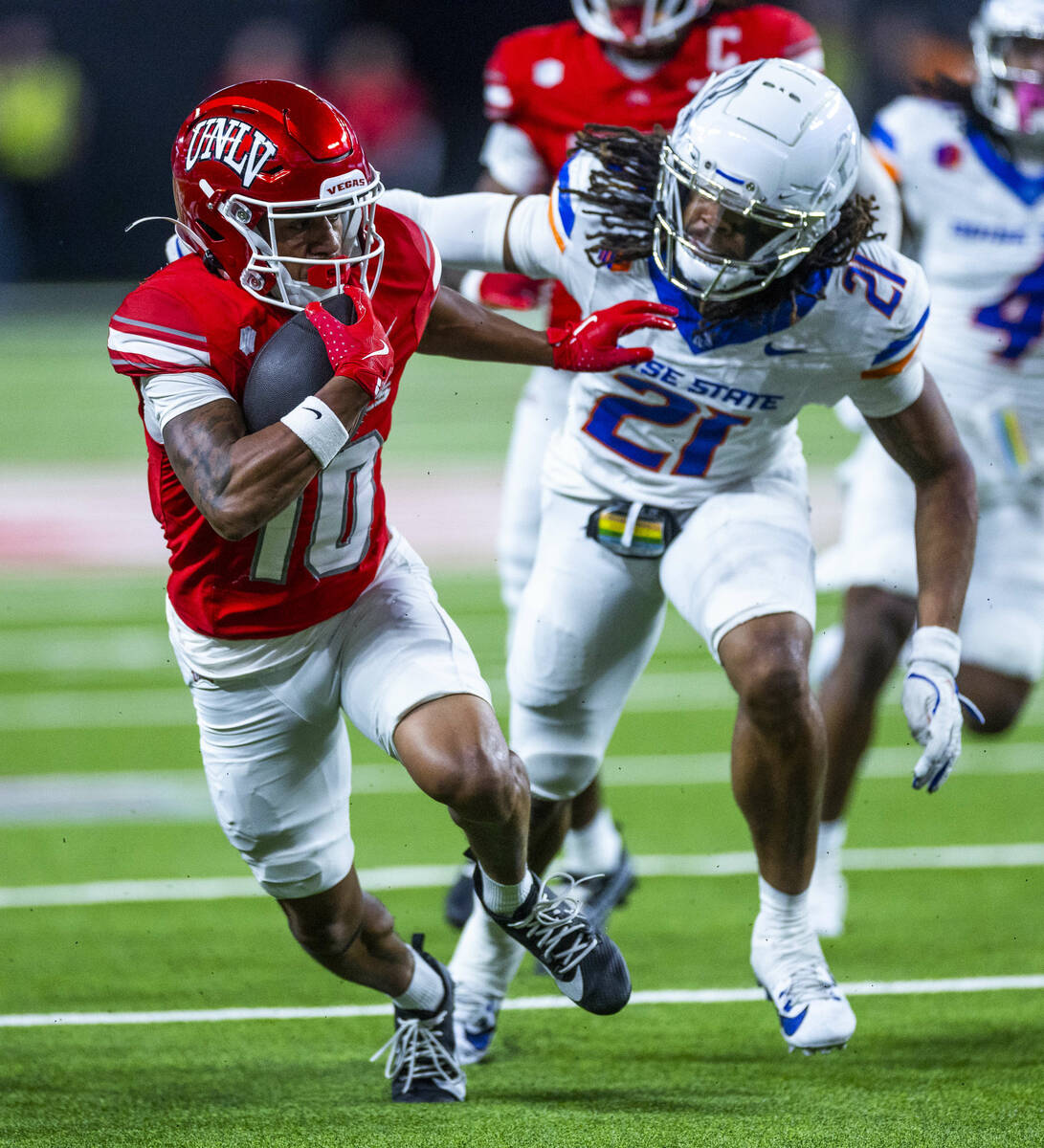UNLV wide receiver DeAngelo Irvin Jr. (10) pushes away from Boise State Broncos safety Zion Was ...
