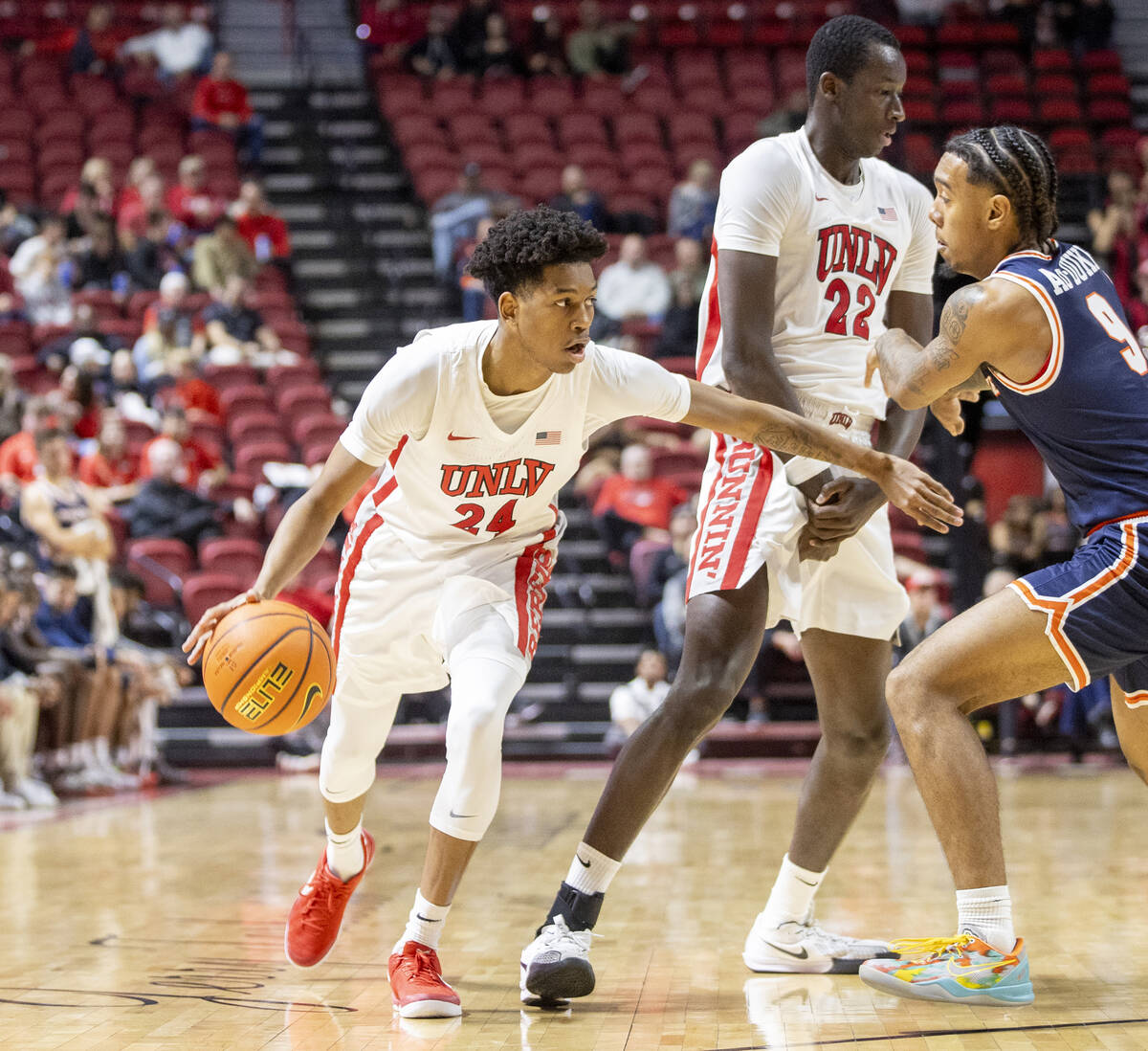 UNLV guard DeMarion Yap (24) runs around forward Pape N'Diaye (22) during the college basketbal ...