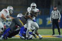 UNLV running back Jai'Den Thomas, right, is tackled by San Jose State linebacker John Ward duri ...