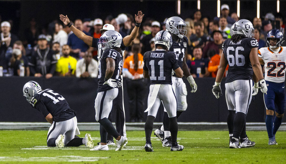 Raiders quarterback Gardner Minshew (15) reacts after being injured during a sack by the Denver ...