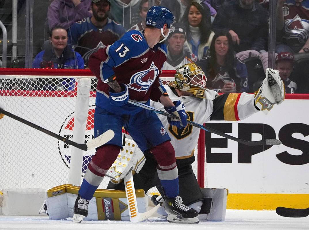 Vegas Golden Knights goaltender Adin Hill, back, makes a glove save of a shot as Colorado Avala ...