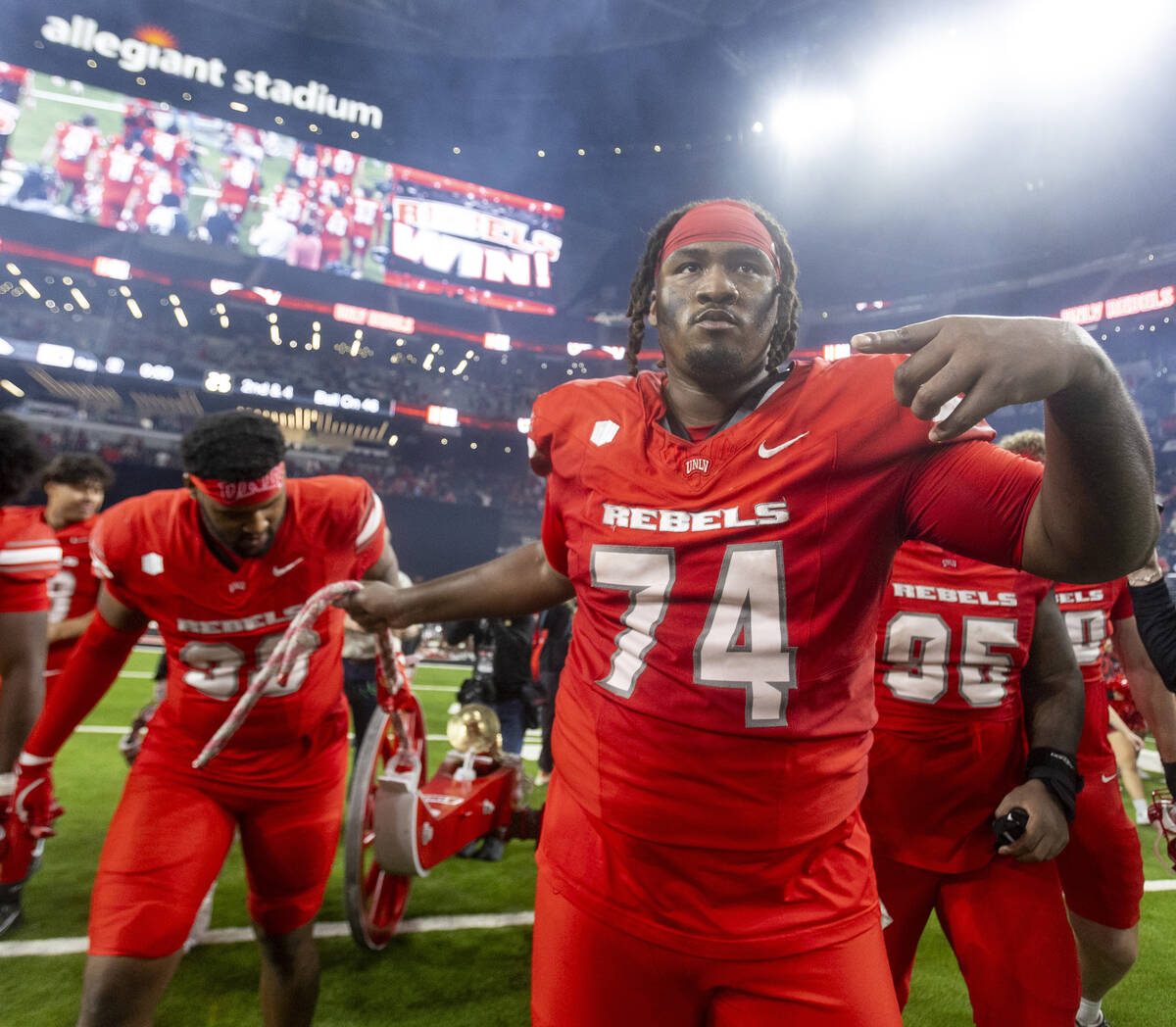 UNLV offensive lineman Jalen St. John (74) wheels the Fremont Cannon to center field after winn ...