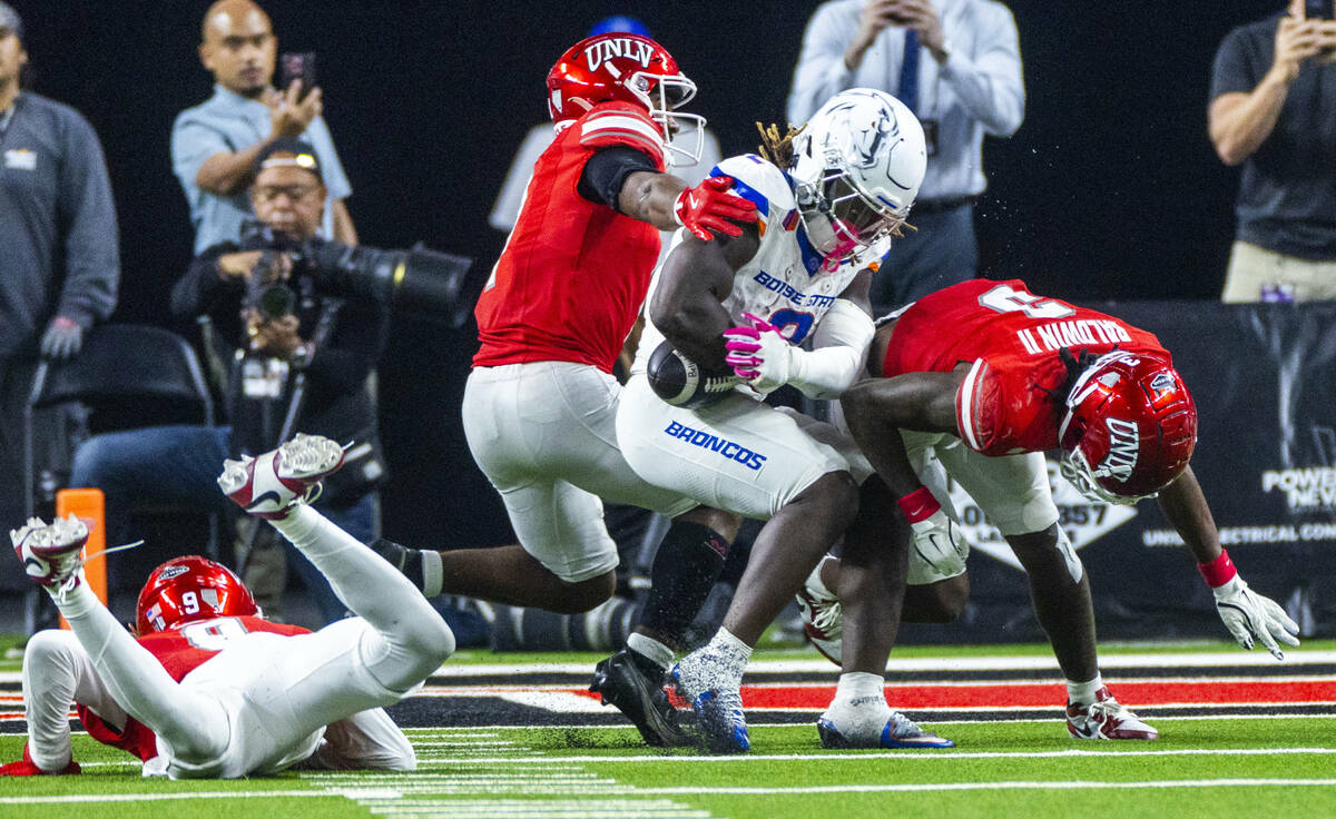 Boise State Broncos running back Ashton Jeanty (2) nearly fumbles the ball after a hit by UNLV ...