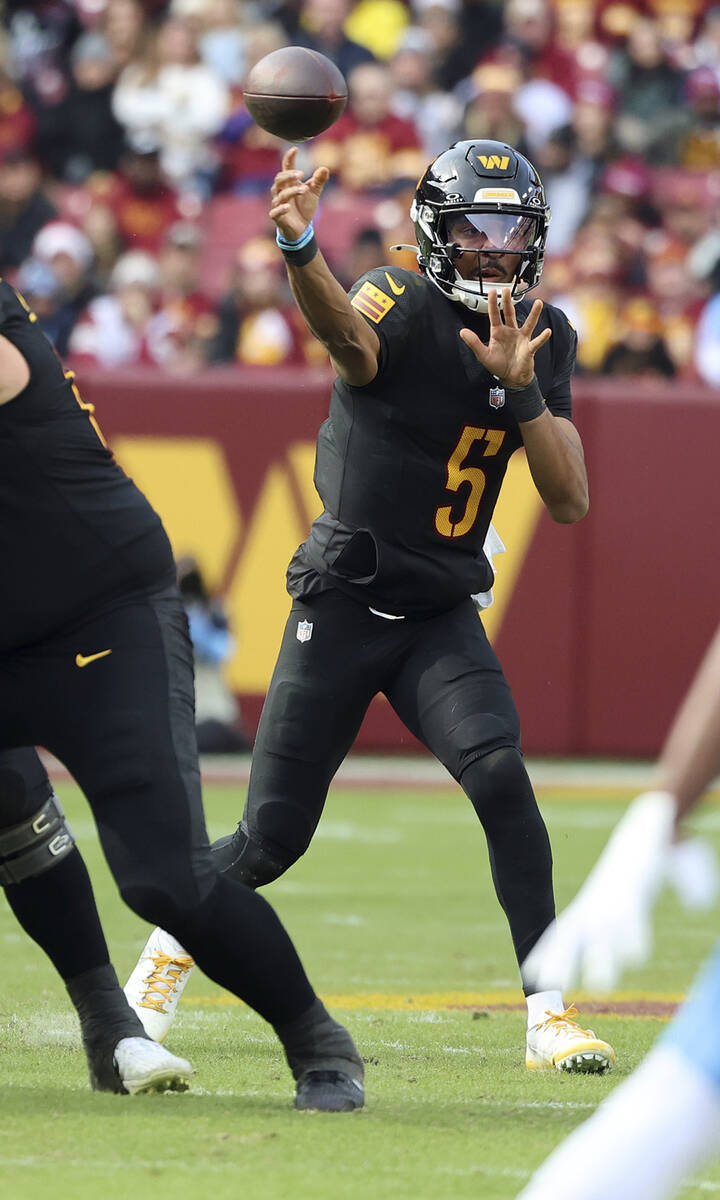 Washington Commanders quarterback Jayden Daniels (5) throws the ball during an NFL football gam ...