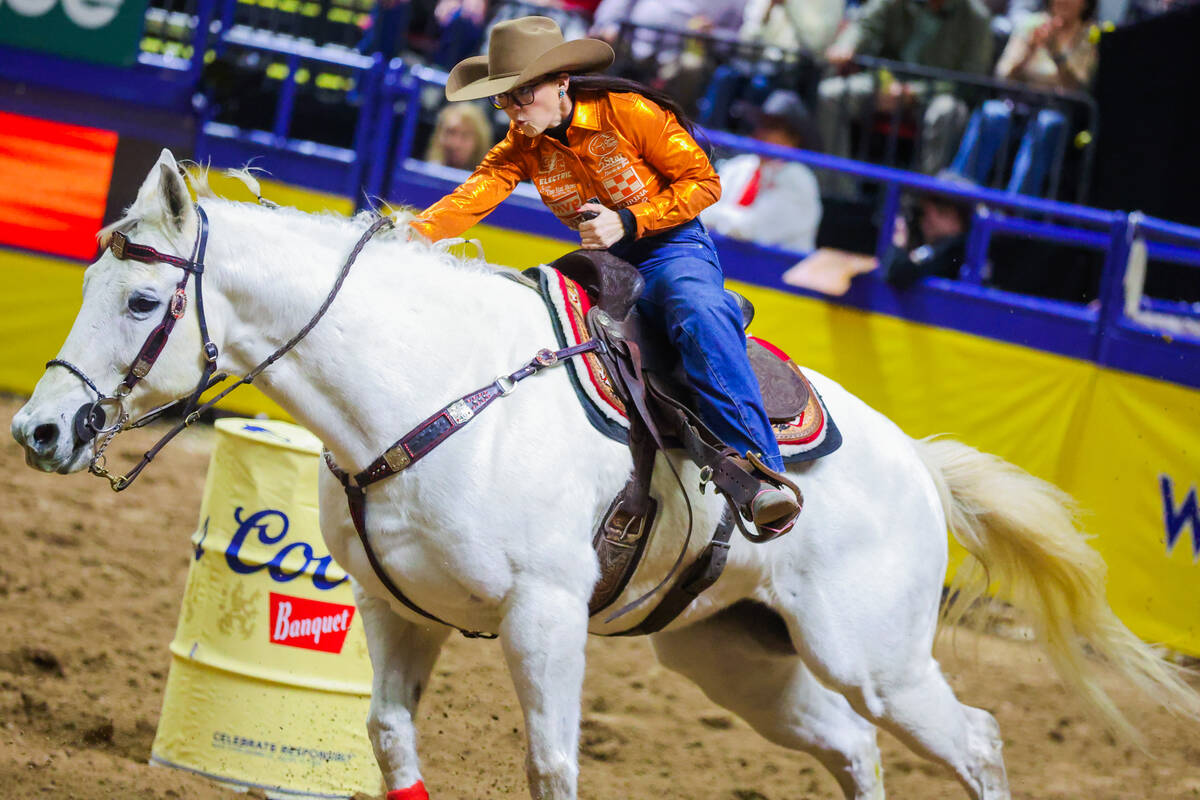 Barrel racer Ashley Castleberry races out of the arena during round three of the National Fina ...
