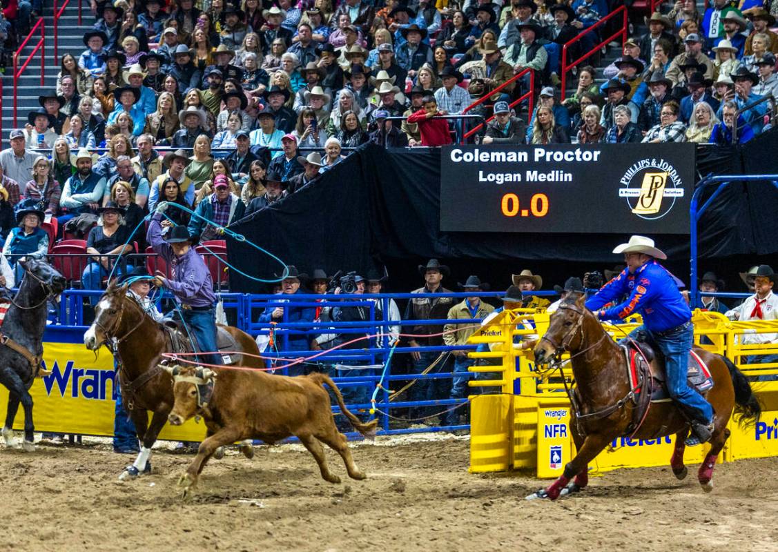 Team Roping Header Coleman Proctor and Heeler Logan Medlin bear down to rope their calf for a w ...
