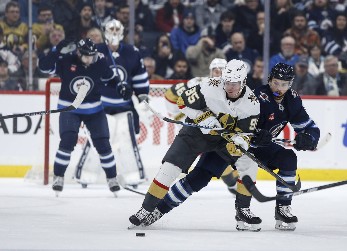 Winnipeg Jets' Mason Appleton (22) defends against Vegas Golden Knights' Victor Olofsson (95) d ...