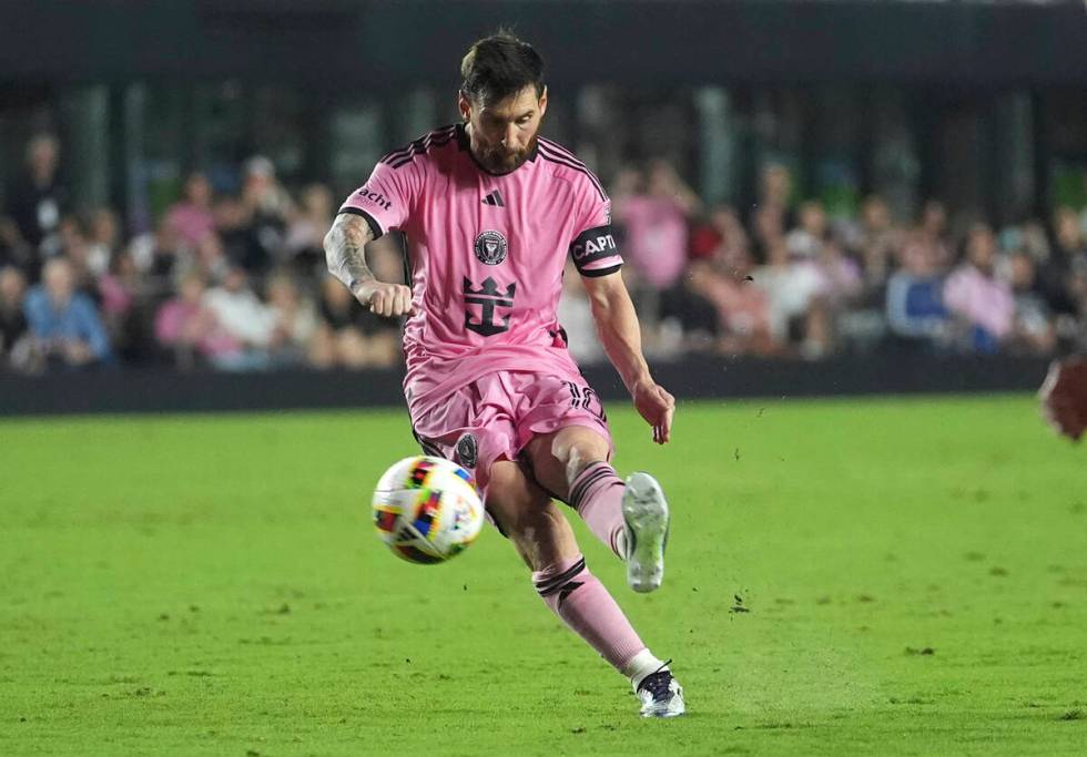 Inter Miami forward Lionel Messi, left, kicks the ball during the second half of their MLS play ...