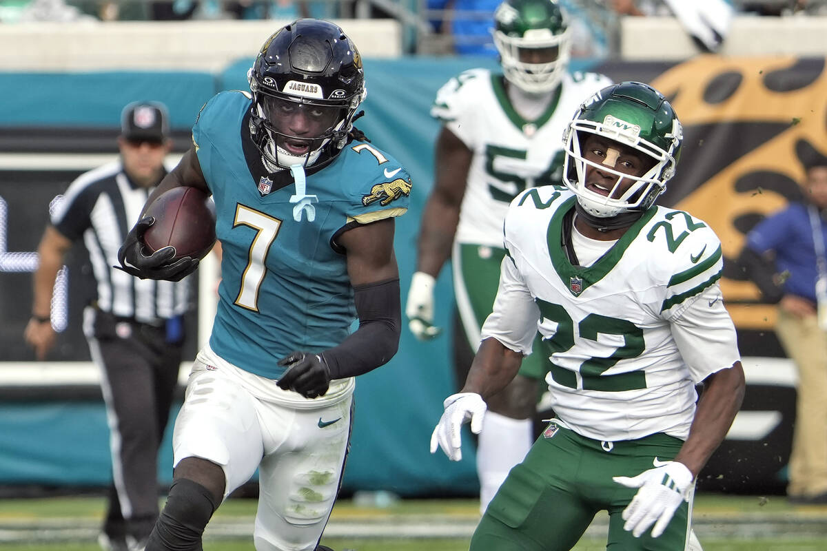 Jacksonville Jaguars wide receiver Brian Thomas Jr. (7) runs past New York Jets safety Tony Ada ...