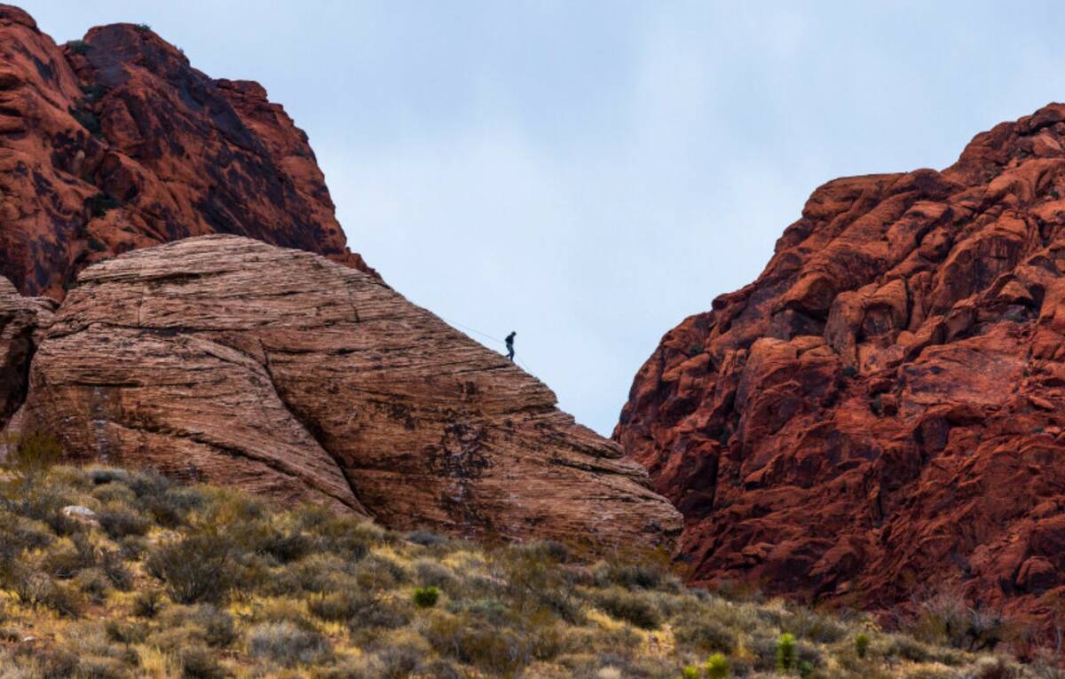 A rock climber works down a line atop a large boulder in Calico Basin on Thursday, Dec. 26, 202 ...