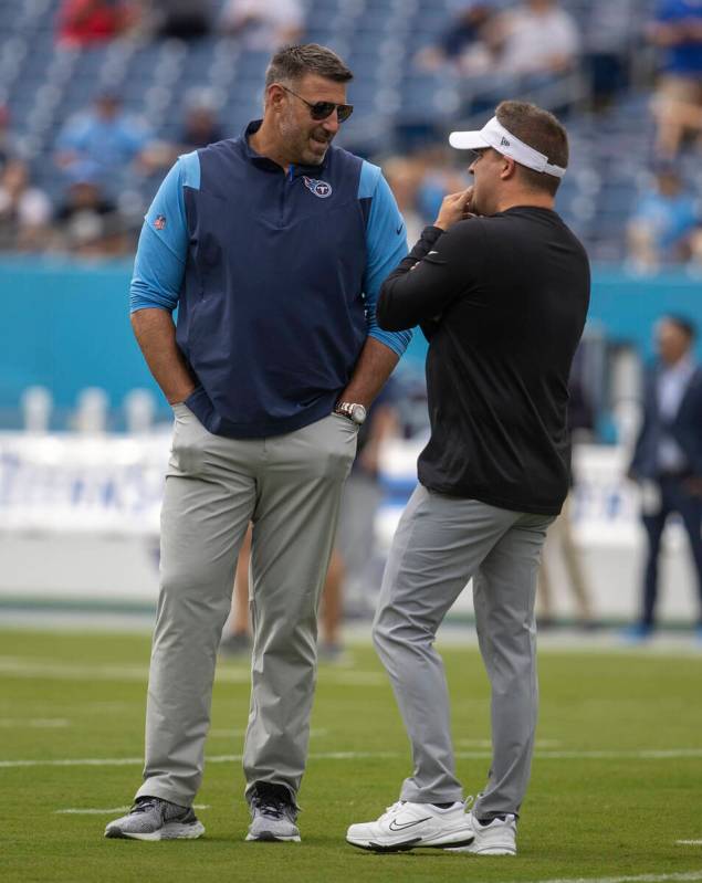 Tennessee Titans head coach Mike Vrabel, left, speaks to Raiders head coach Josh McDaniels befo ...