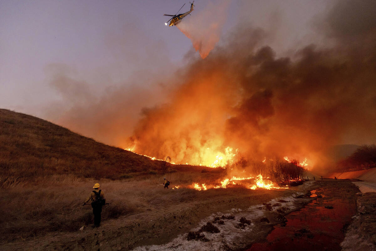 Fire crews battle the Kenneth Fire in the West Hills section of Los Angeles, Thursday, Jan. 9, ...