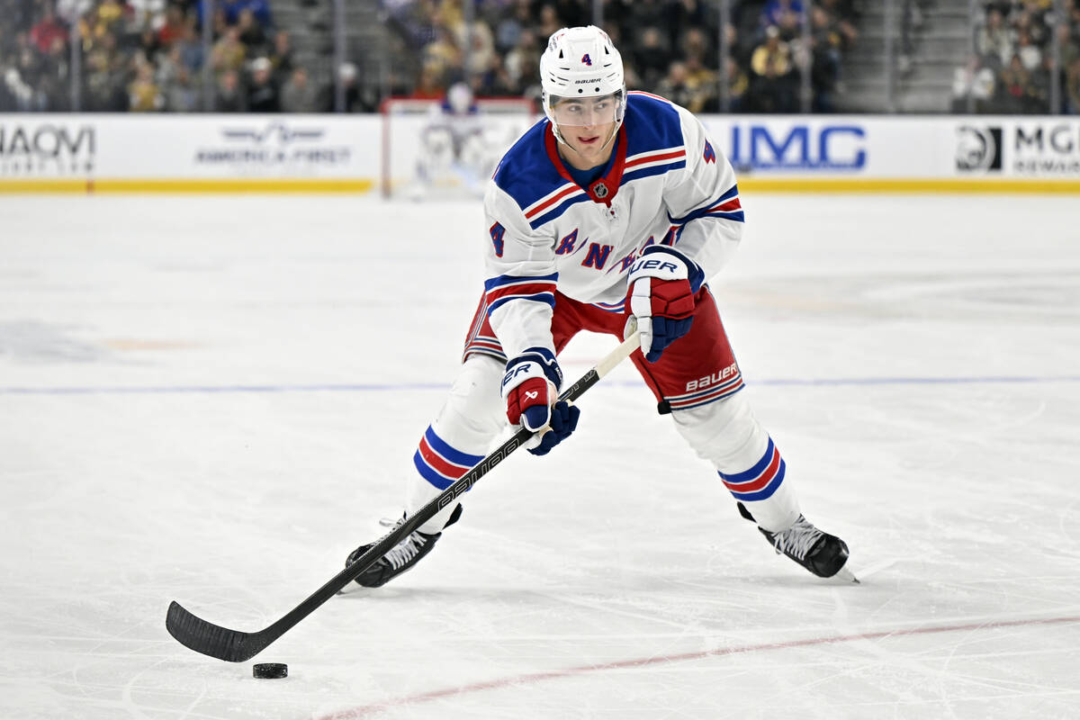New York Rangers defenseman Braden Schneider (4) skates with the puck against the Vegas Golden ...