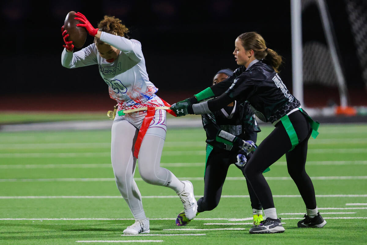Liberty wide receiver Janae Dunaway (20) gets her flags yanked during a high school girls flag ...