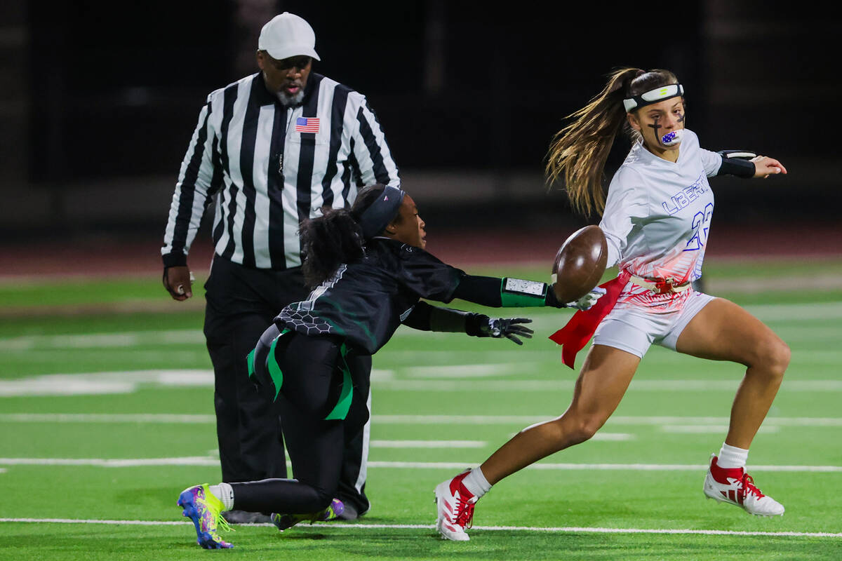 Liberty quarterback Kaylie Philips scrambles during a high school girls flag football game betw ...