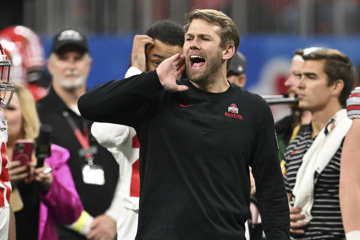 Ohio State quarterbacks coach Corey Dennis speaks on the turf before the Peach Bowl NCAA colleg ...