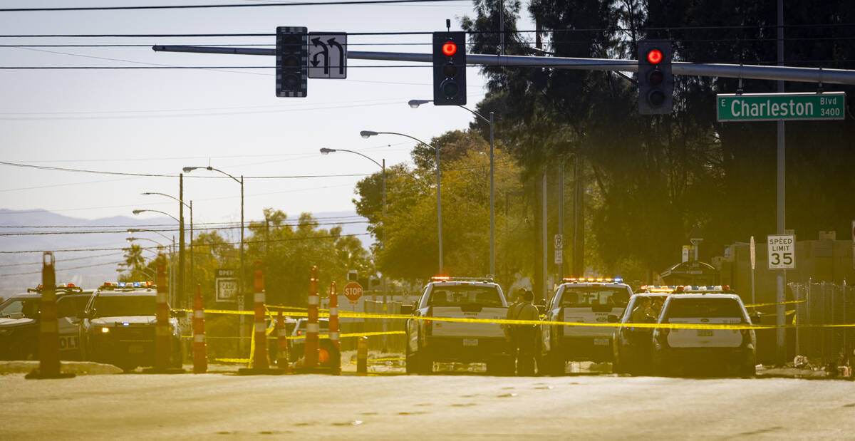 Las Vegas police investigate the scene of a crashed car at Charleston Boulevard and Pecos Road, ...
