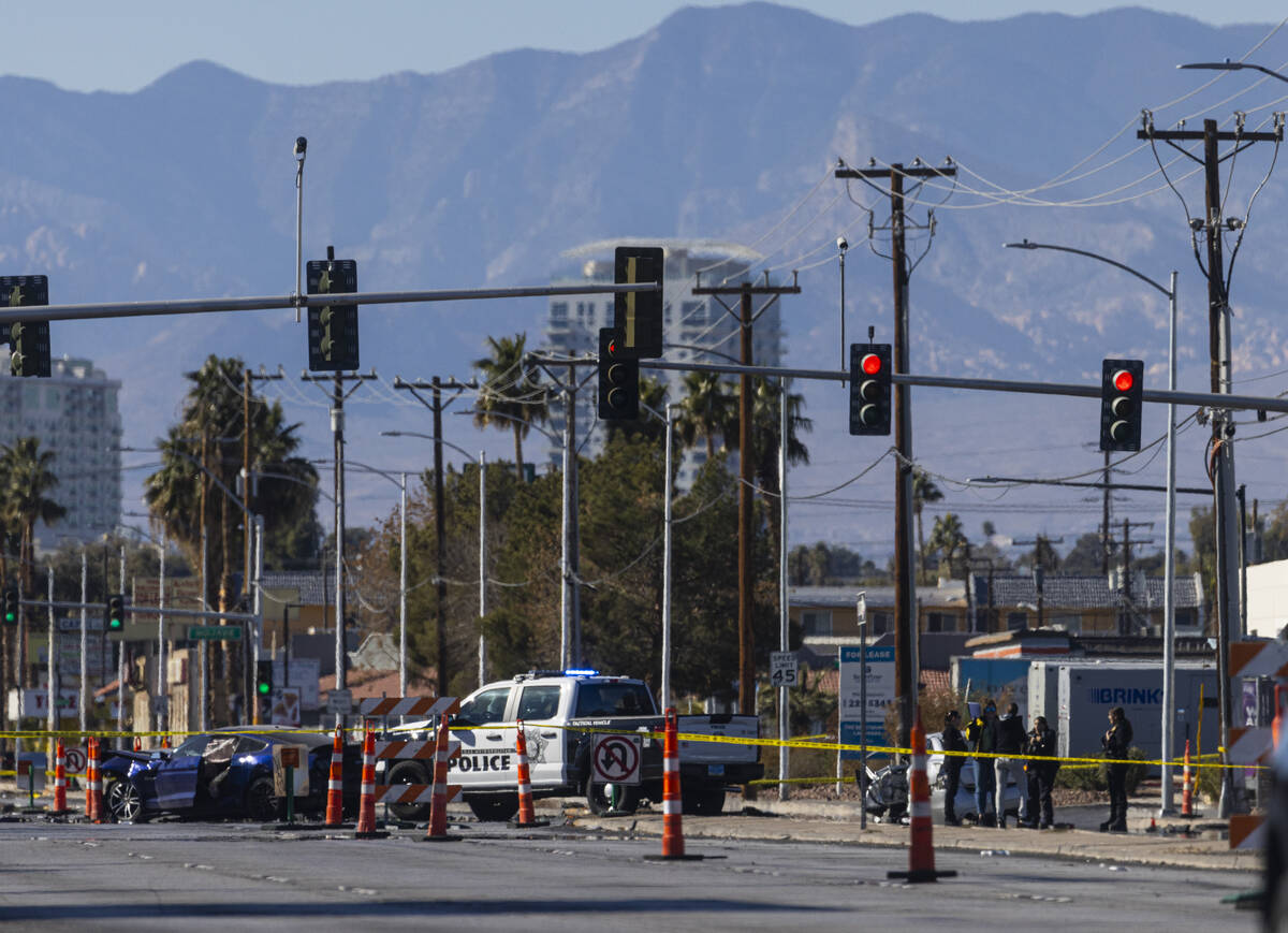 Las Vegas police investigate the scene of a car crash following the pursuit of a homicide suspe ...