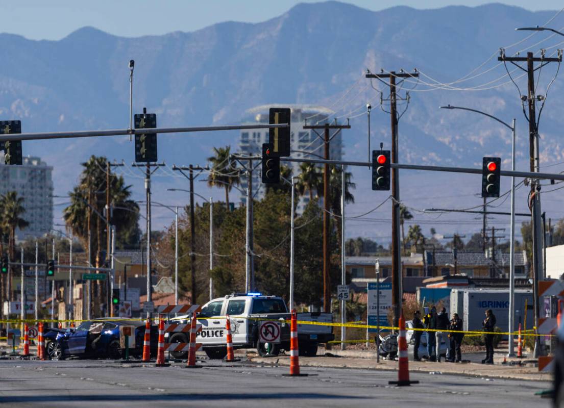 Las Vegas police investigate the scene of a car crash following the pursuit of a homicide suspe ...