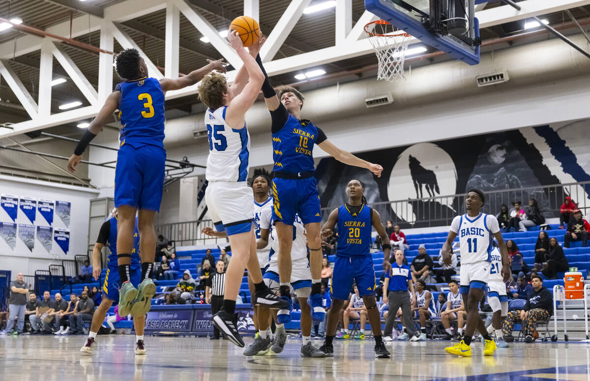 Basic forward Hunter McGory (35) grabs the rebound between Sierra Vista guard Jayvion Wall (3) ...