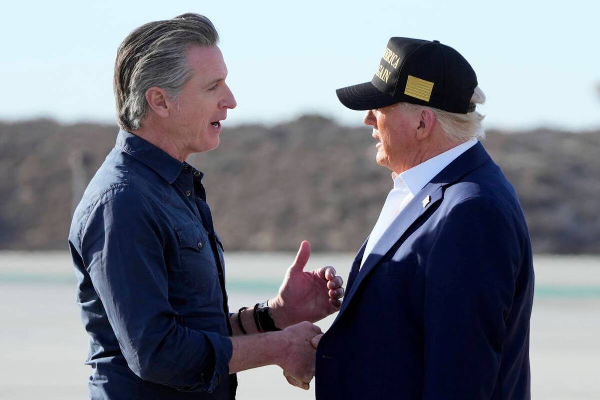 President Donald Trump talks with California Gov. Gavin Newsom after arriving on Air Force One ...