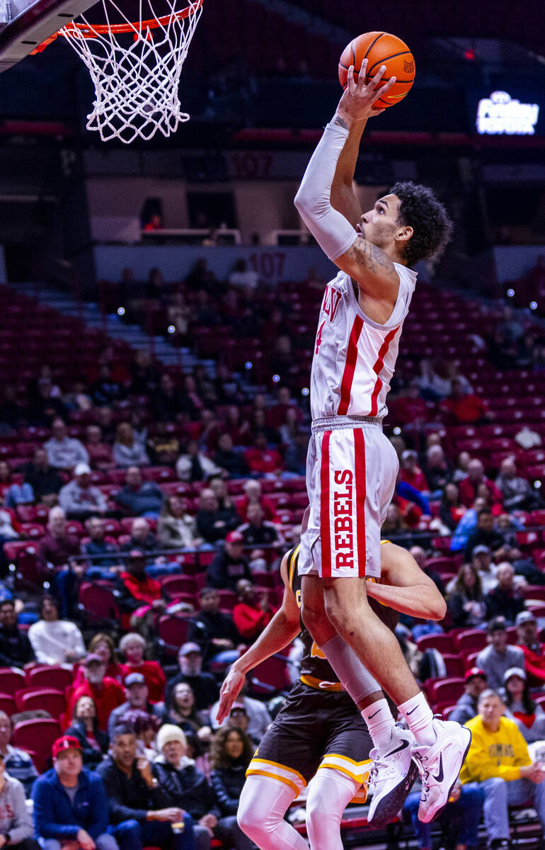 UNLV guard Jailen Bedford (14) dunks the ball past Wyoming Cowboys guard Kobe Newton (2) during ...