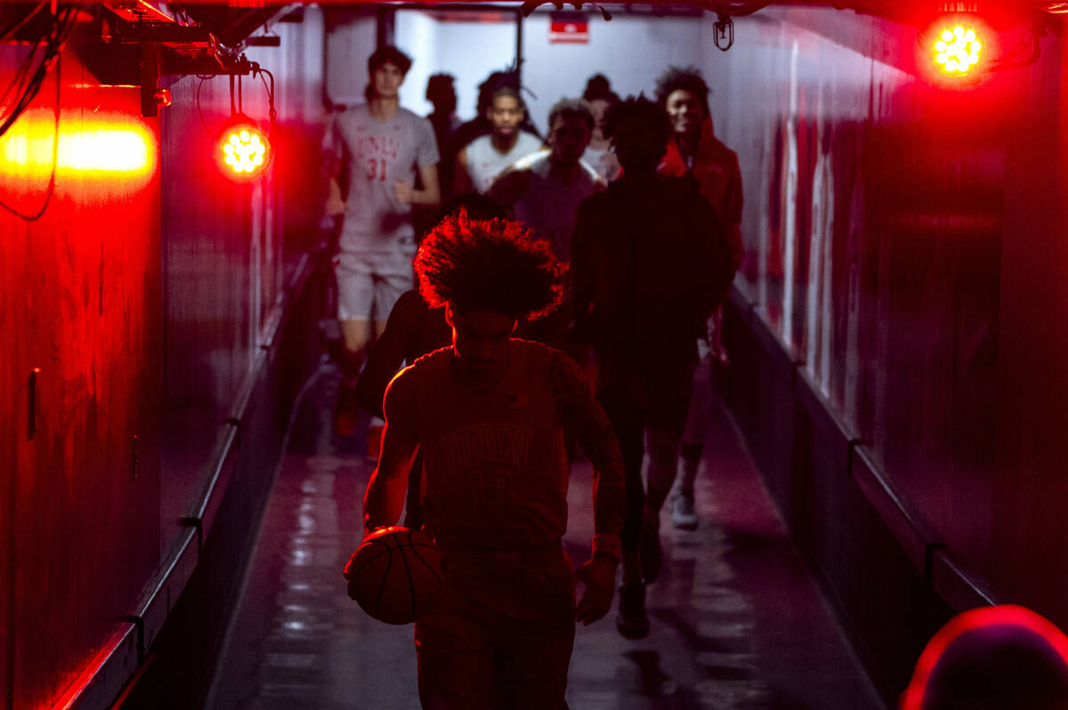 UNLV players enter the court from their tunnel to face the Wyoming Cowboys during the first hal ...