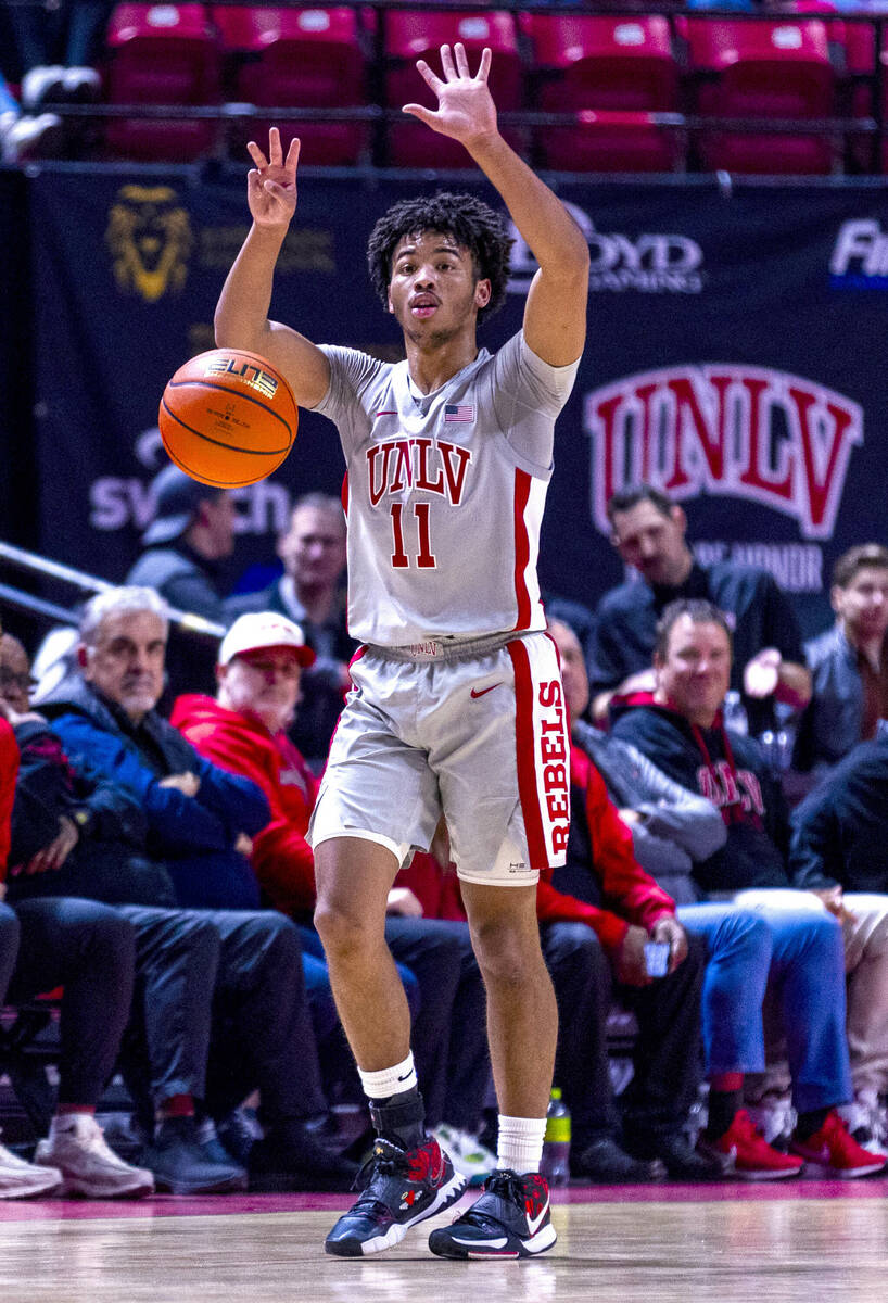 UNLV guard Dedan Thomas Jr. (11) signals his teammates as he takes the ball up the court agains ...