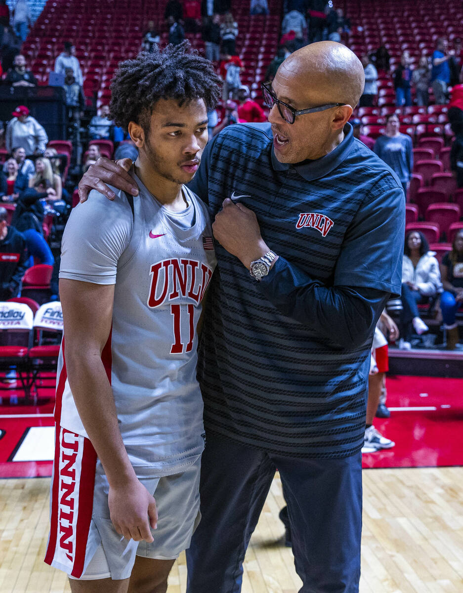 UNLV guard Dedan Thomas Jr. (11) is consoled after the game against the Wyoming Cowboys followi ...