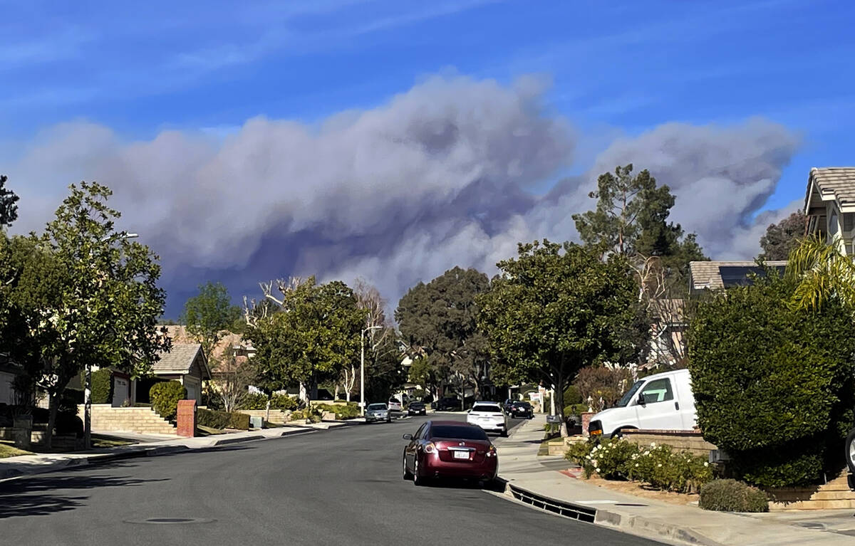 A large plume of smoke caused by the Hughes Fire rises from Castaic Lake as seen from a neighbo ...