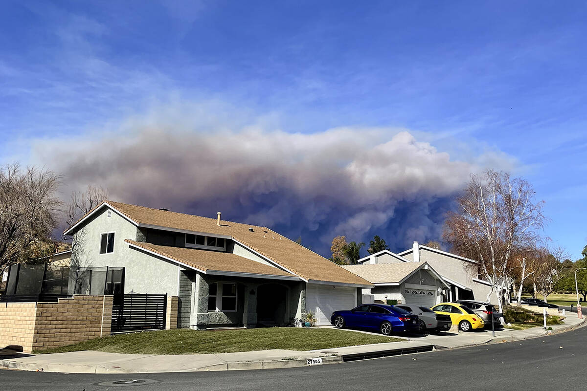 A large plume of smoke caused by the Hughes Fire rises from Castaic Lake as seen from a neighbo ...