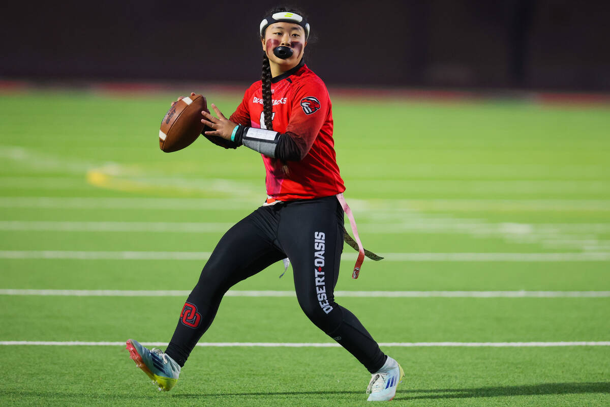 Desert Oasis quarterback Akemi Higa looks to throw the ball during a flag football game between ...
