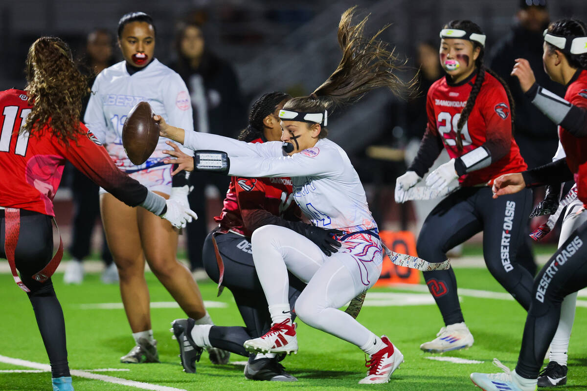 Liberty quarterback Kaylie Phillips (14) gets her flag yanked as she scrambles during a flag fo ...