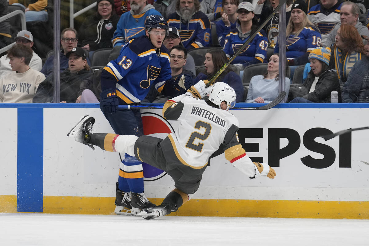 St. Louis Blues' Alexey Toropchenko (13) checks Vegas Golden Knights' Zach Whitecloud (2) durin ...