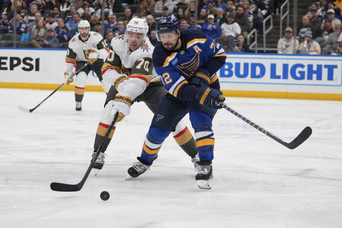 Vegas Golden Knights' Tanner Pearson (70) and St. Louis Blues' Justin Faulk (72) battle for a l ...