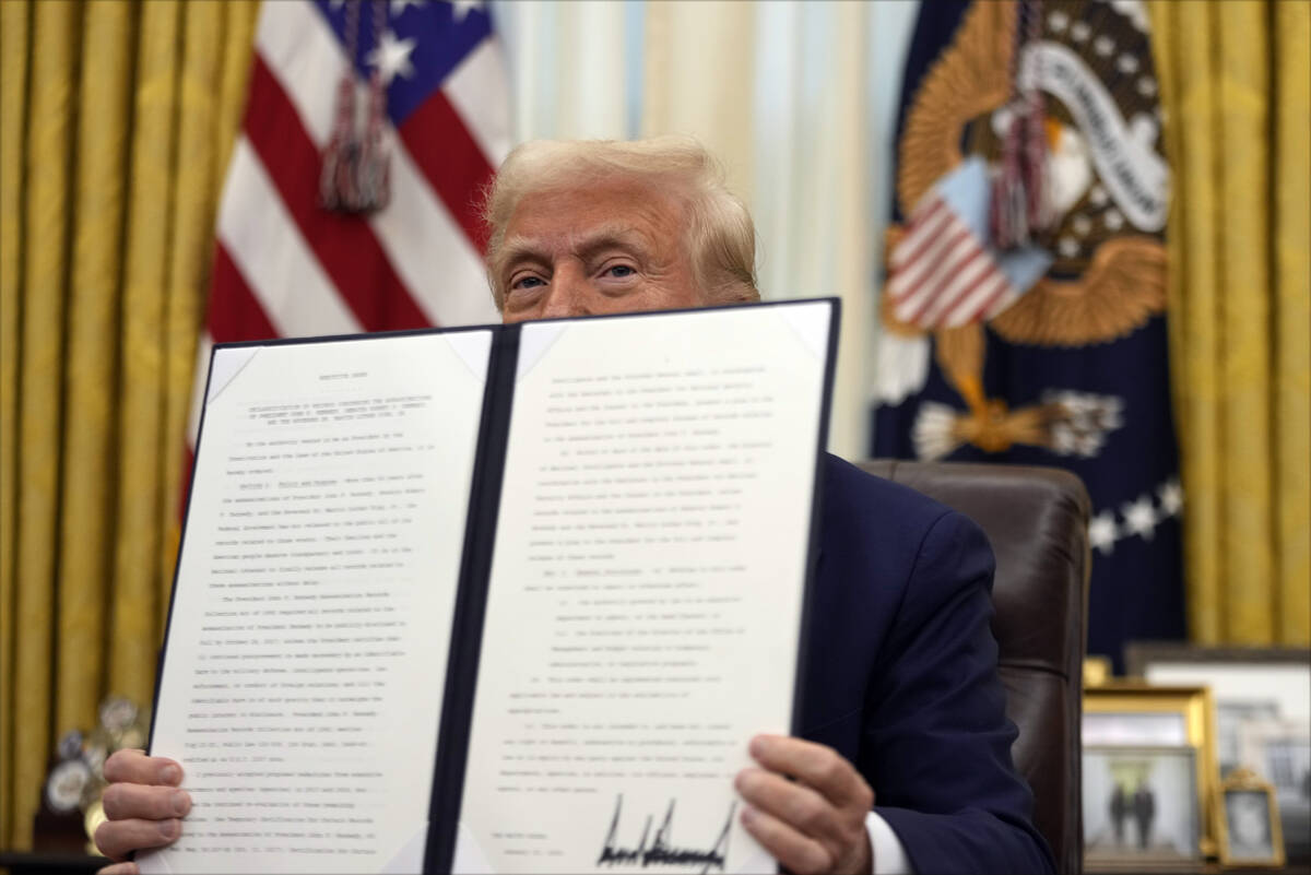 President Donald Trump holds a signed an executive order regarding the declassification and rel ...
