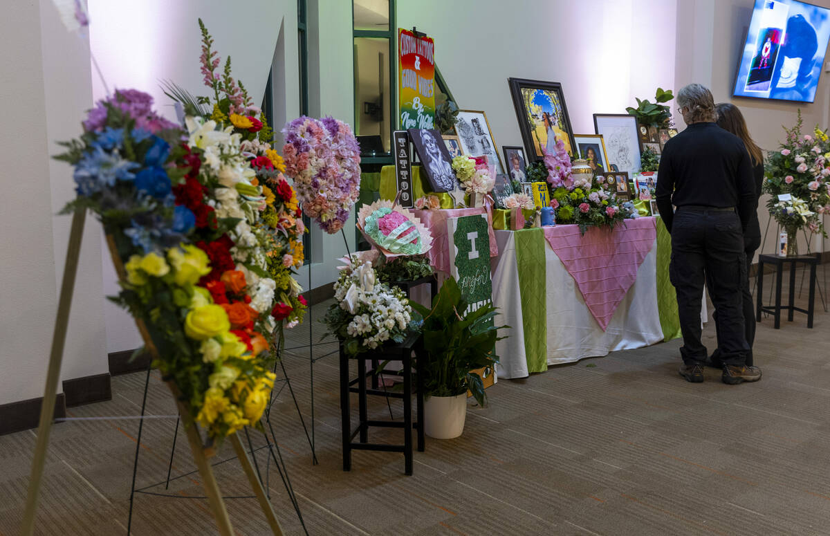 Attendees look through some memorabilia during a remembrance gathering for Renise “NeNe” Wo ...