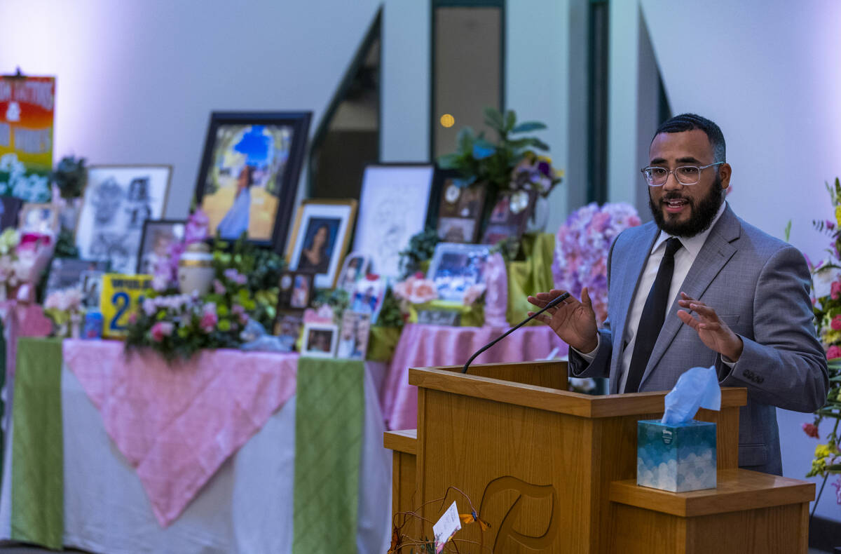 Associate Pastor Elder Trenton Holmes offers a scripture reading during a remembrance gathering ...