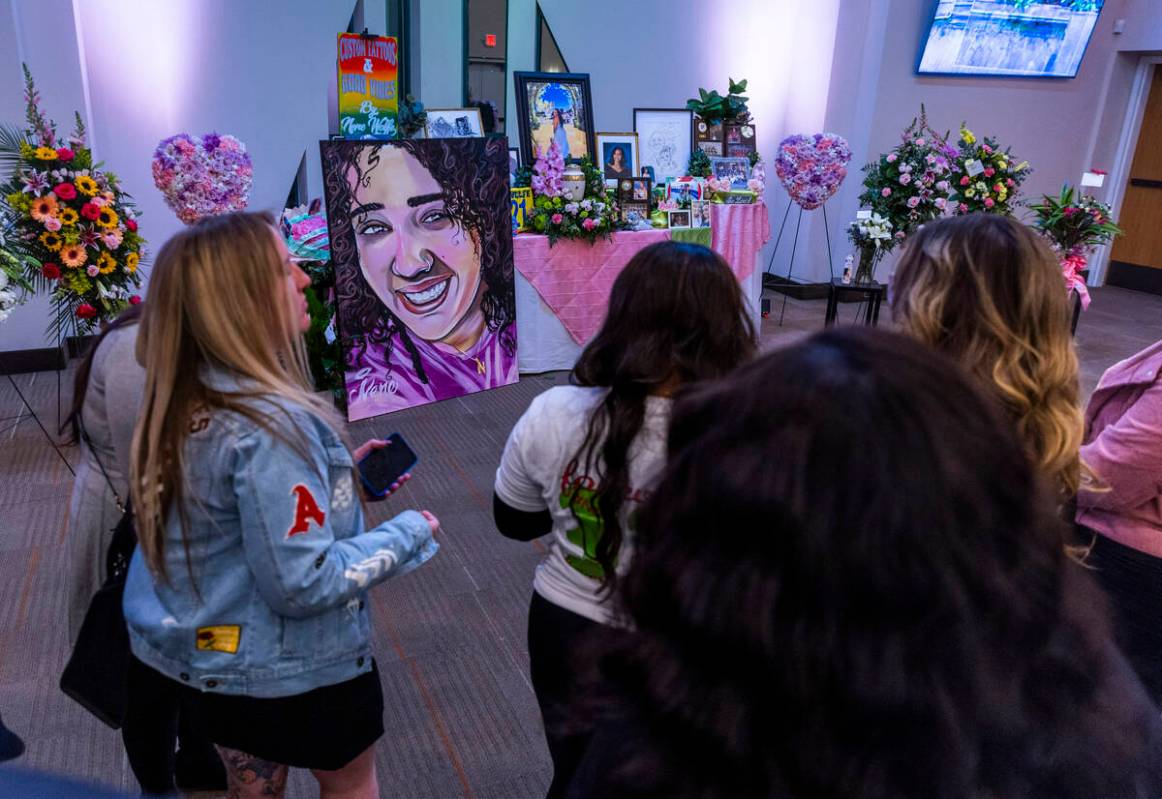 Friends gather amongst a table of mementos and a new painting by artist Big Fox during a rememb ...