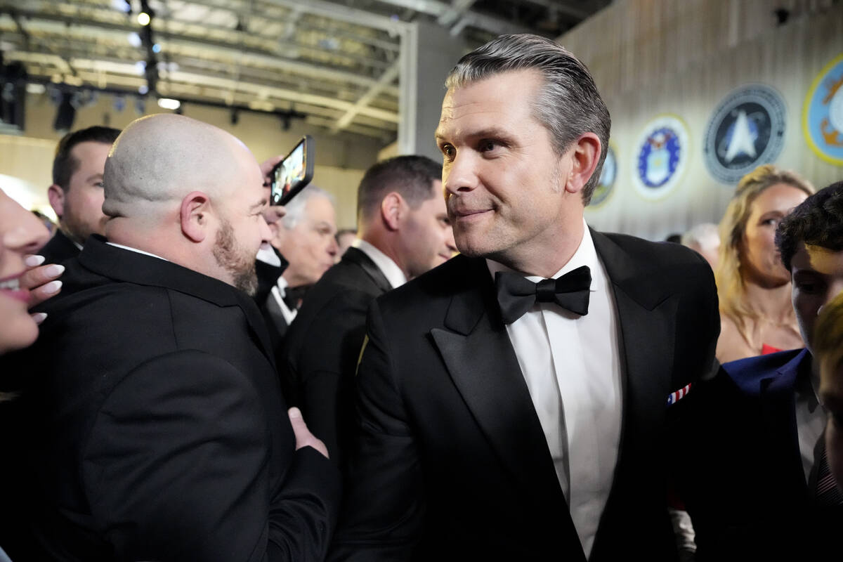 Defense Secretary nominee Pete Hegseth, center, attends the Commander in Chief Ball, Monday, Ja ...