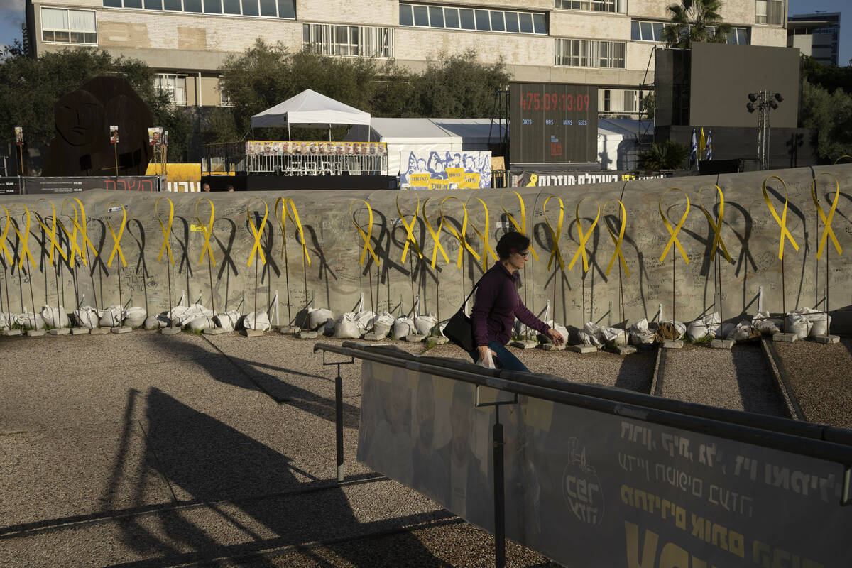 Yellow ribbons for hostages held by the Hamas militant group in the Gaza Strip line a represent ...