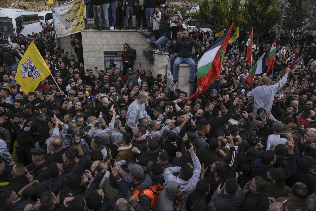 Palestinian prisoners are greeted by a crowd after being released from Israeli prison following ...
