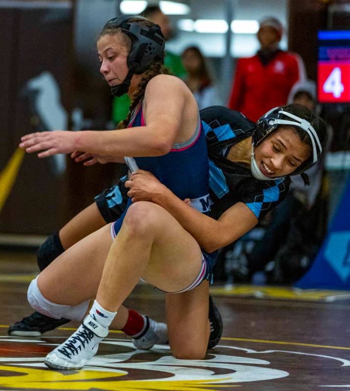 Shadow Ridge’s Makayla Power is pulled down by Centennial’s Mya Bardoni during th ...