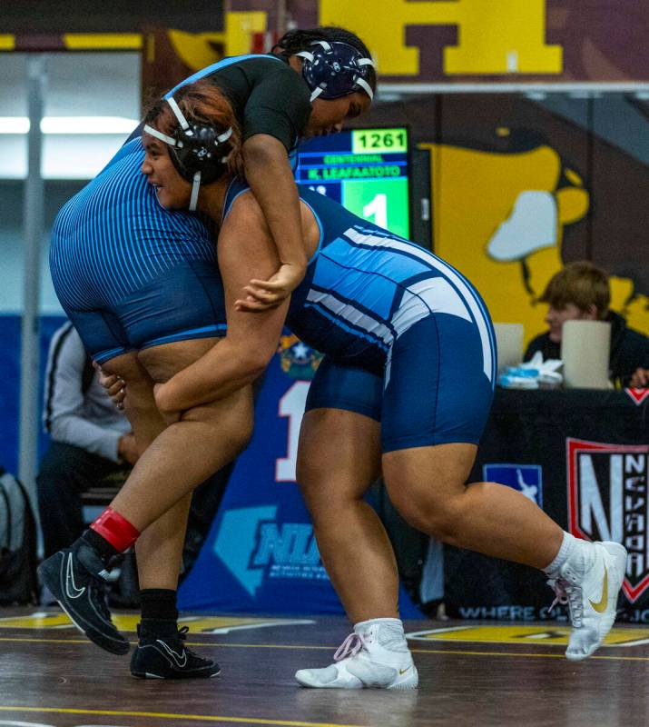 Canyon Springs’ Isabella Gray is lifted up by Centennial’s Kitana Leafaatoto duri ...