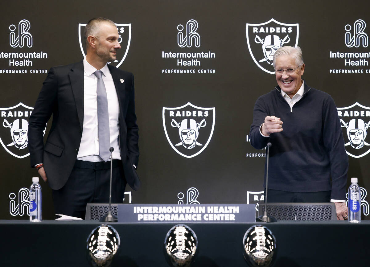 The new Raiders general manager John Spytek, left, watches as new head coach Pete Carroll react ...