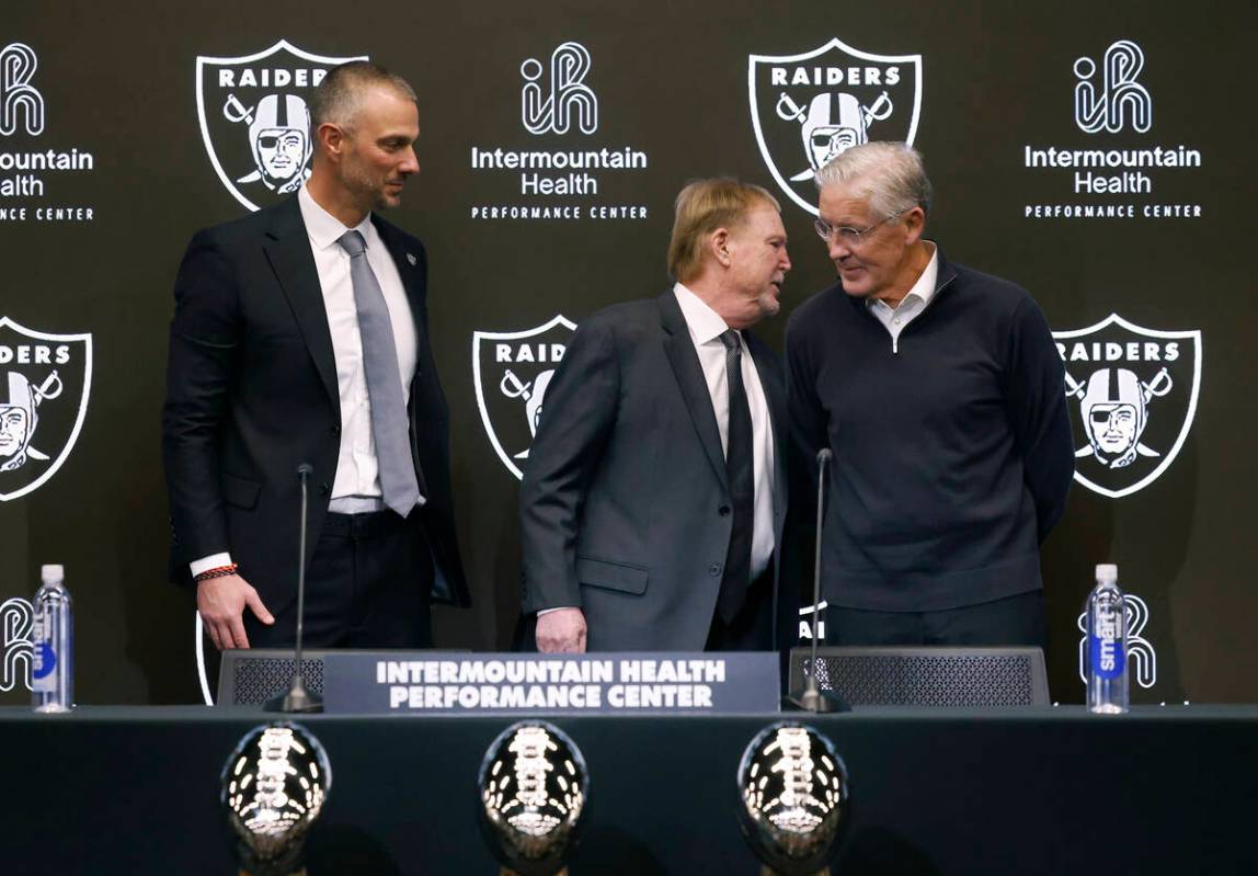 Raiders owner Mark Davis, center, chats with the new head coach Pete Carroll as new general man ...